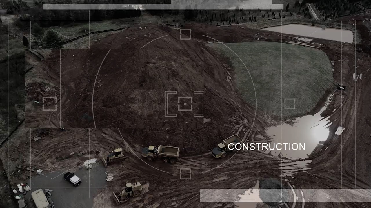 Aerial drone view of construction site with earthmoving equipment