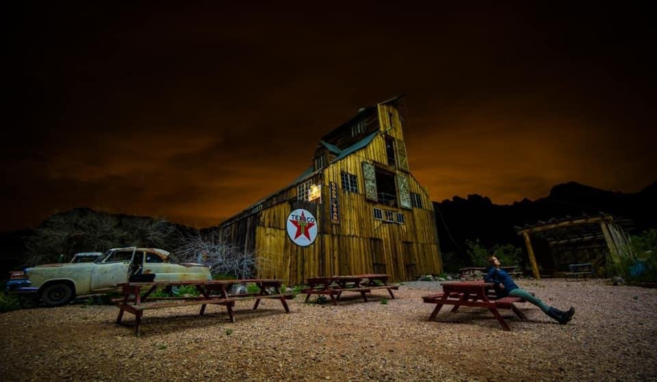 Night shot of ghost town building with vintage Texaco sign